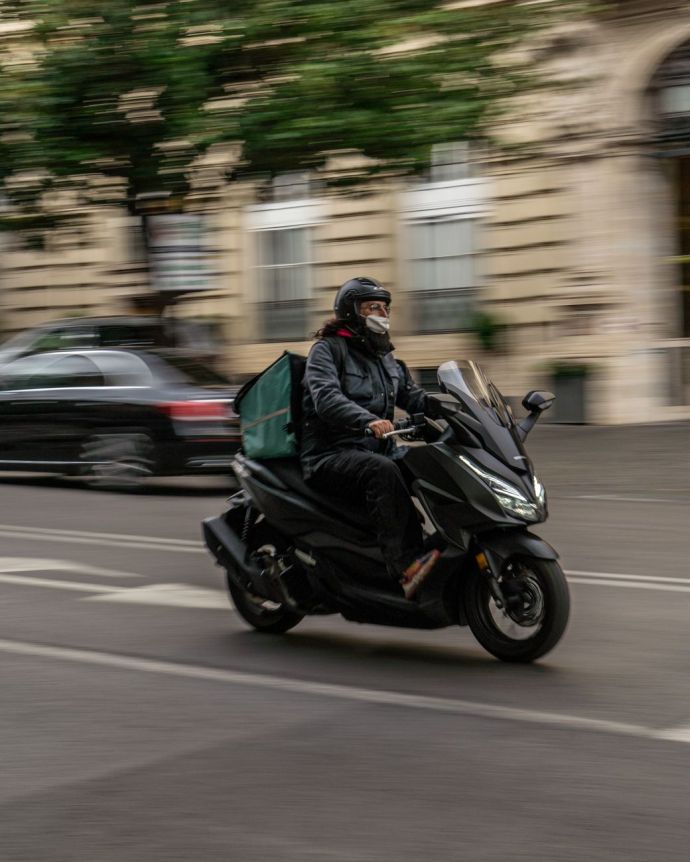 Self-employed Deliveroo scooter rider working in London