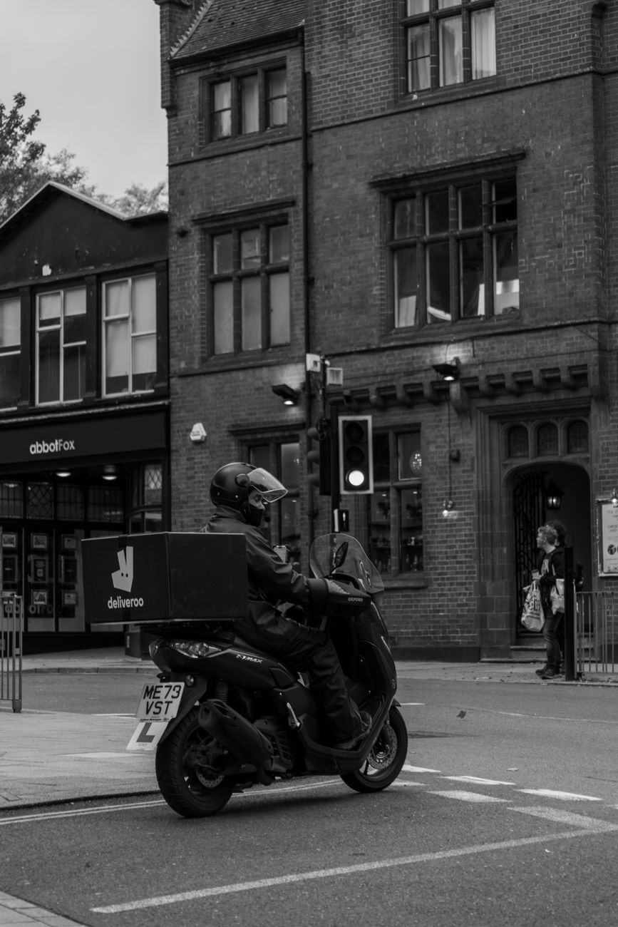 Self-employed Deliveroo scooter rider working in London