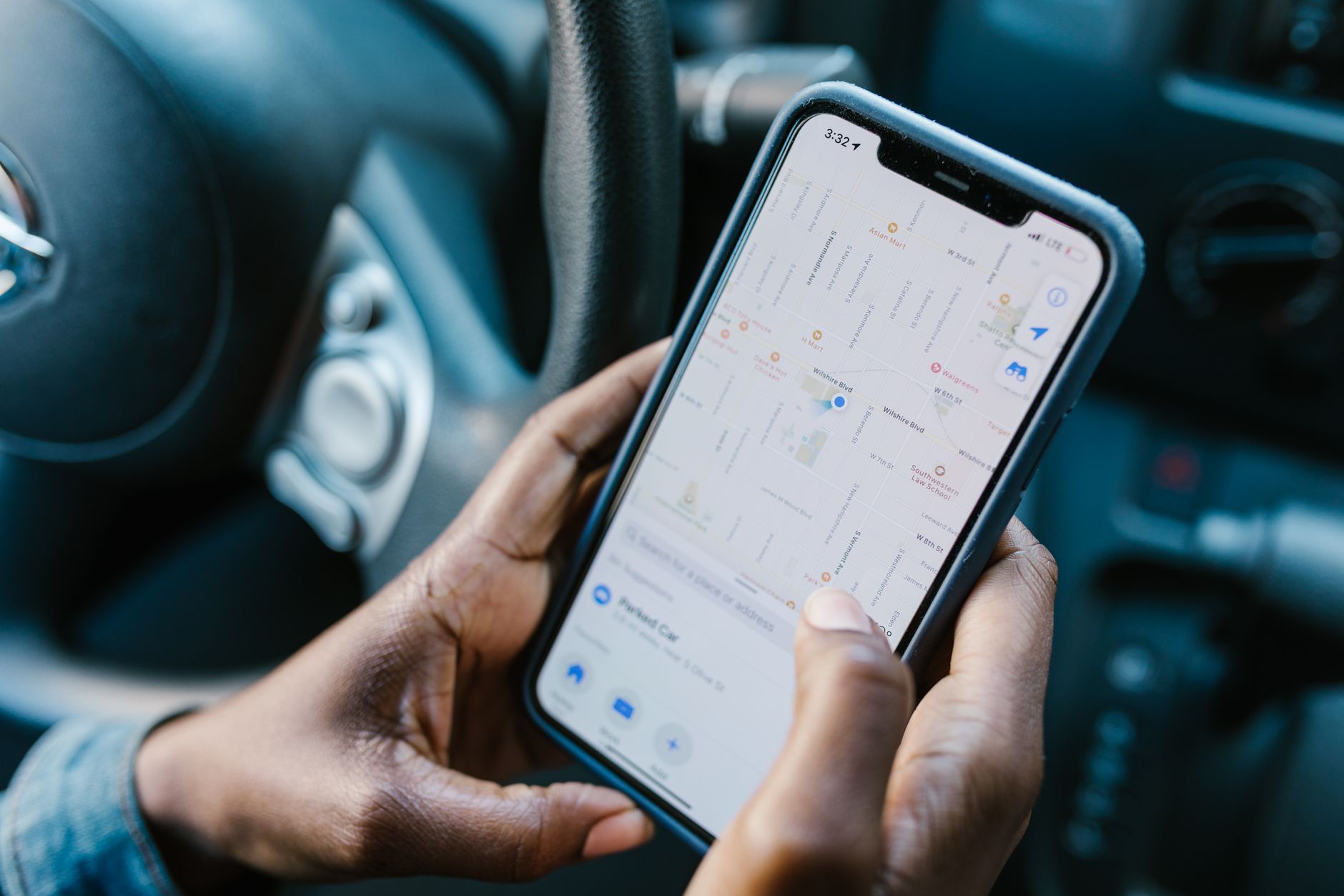 a person tracking there mileage from their phone in a car

